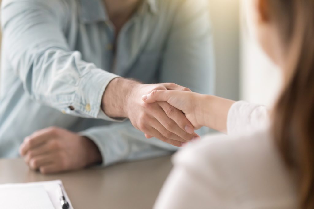 premium financed life insurance picture of two people shaking hands